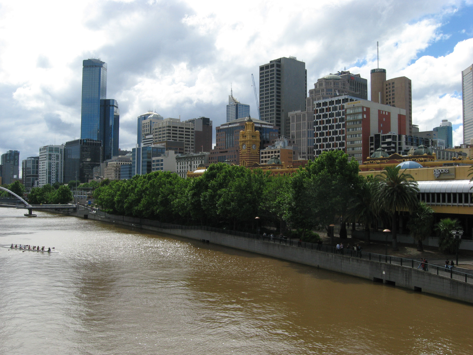 Flinders St Station by the Yarra & the business district behind it